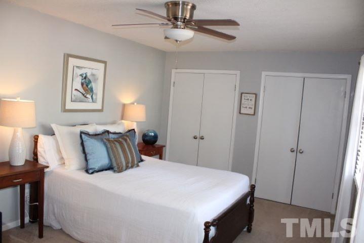 1012 Mockingbird Drive Raleigh, NC 27615 - Photo 14 of 26 a bedroom with a bed and a lamp