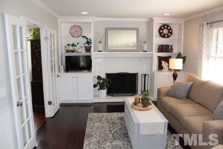1012 Mockingbird Drive Raleigh, NC 27615 - Photo 4 of 26 a living room with furniture and a fireplace