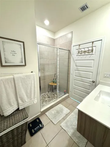 a bathroom with a sink a mirror and a shower