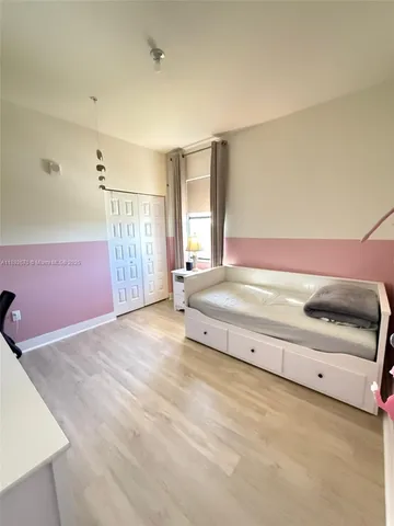 a spacious bedroom with a bed and a window