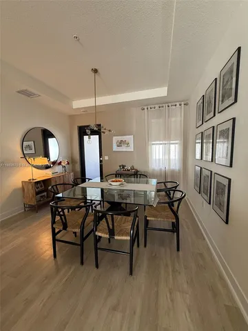 a view of a dining room with furniture window and wooden floor