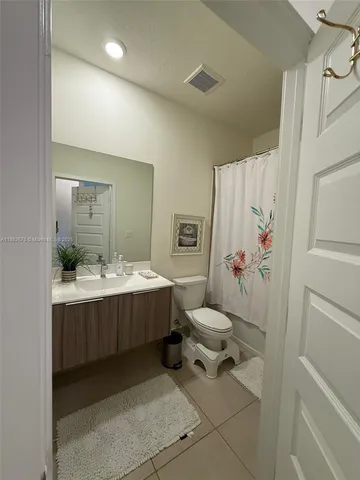 a bathroom with a sink mirror vanity and toilet