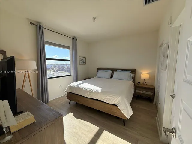 a bedroom with a bed and a window