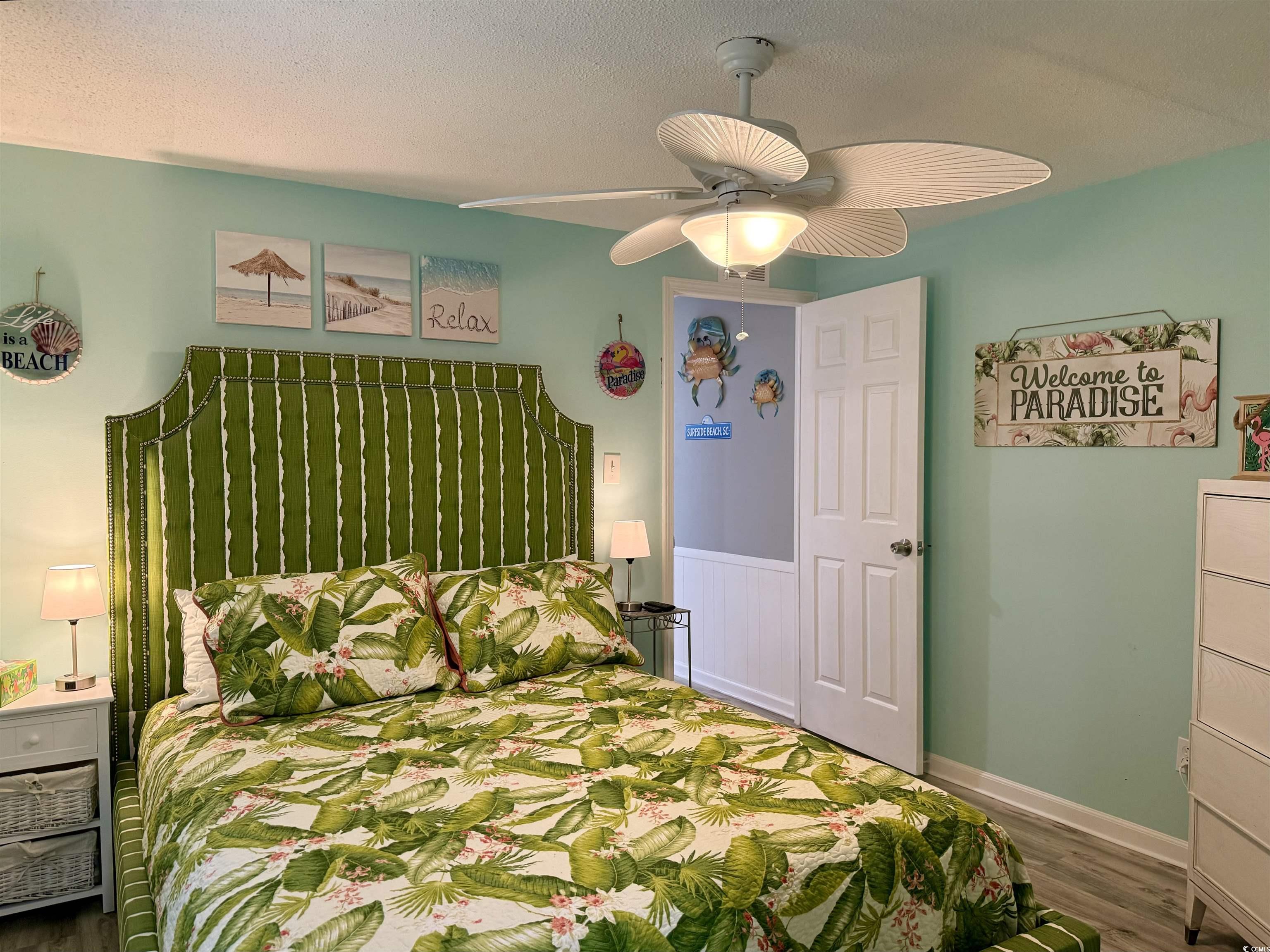 523 Sandpebble Surfside Beach, SC 29575 - Photo 16 of 31 Bedroom with wood-type flooring, a textured ceilin