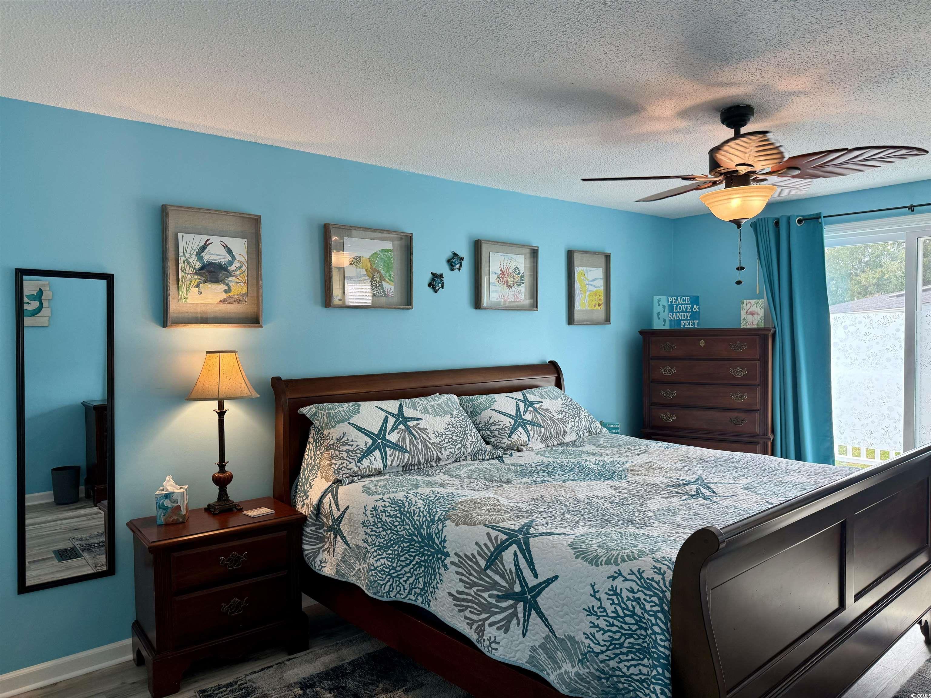 523 Sandpebble Surfside Beach, SC 29575 - Photo 20 of 31 Bedroom featuring ceiling fan, a textured ceiling,