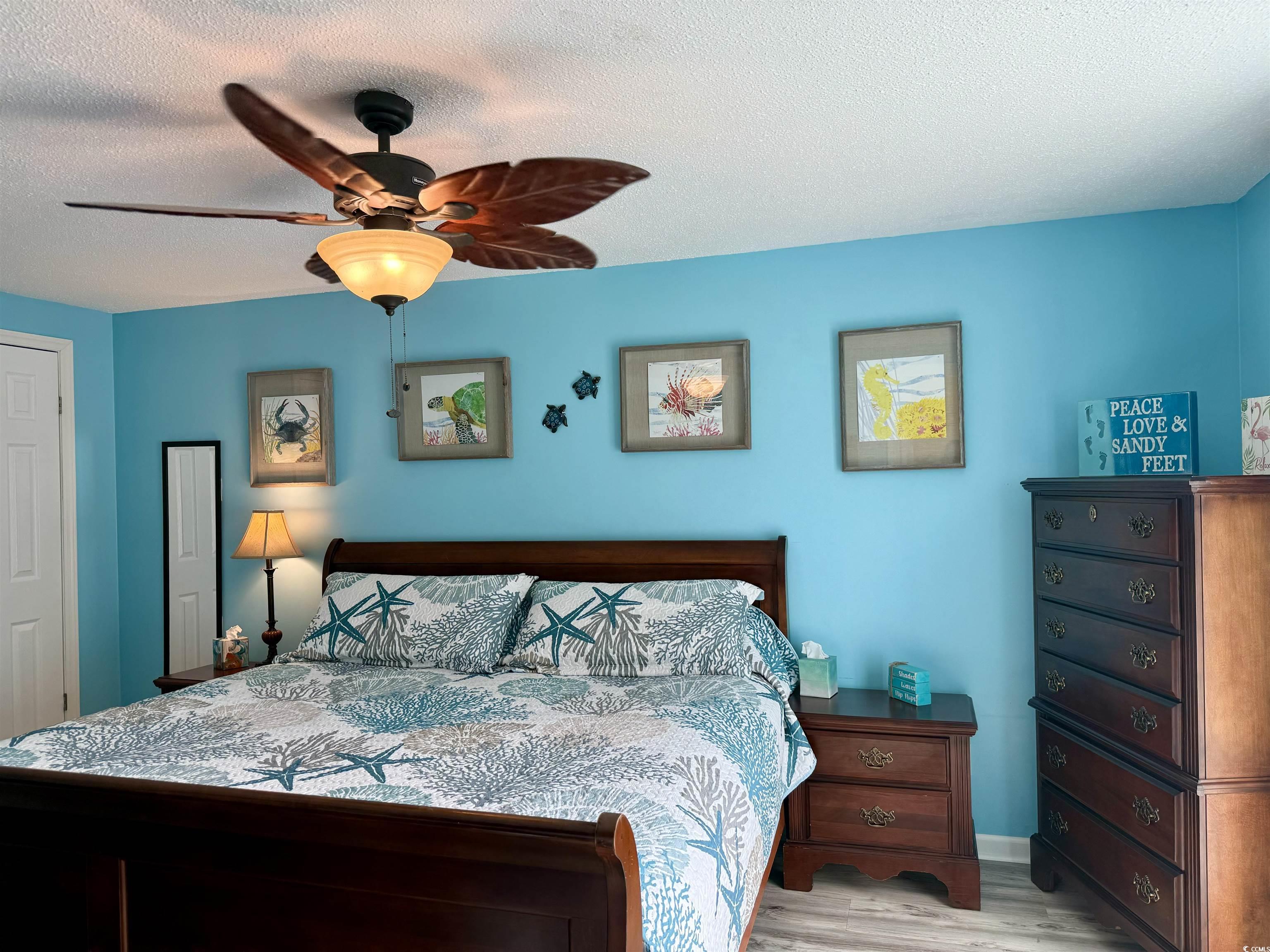 523 Sandpebble Surfside Beach, SC 29575 - Photo 23 of 31 Bedroom with a textured ceiling, light wood-type f