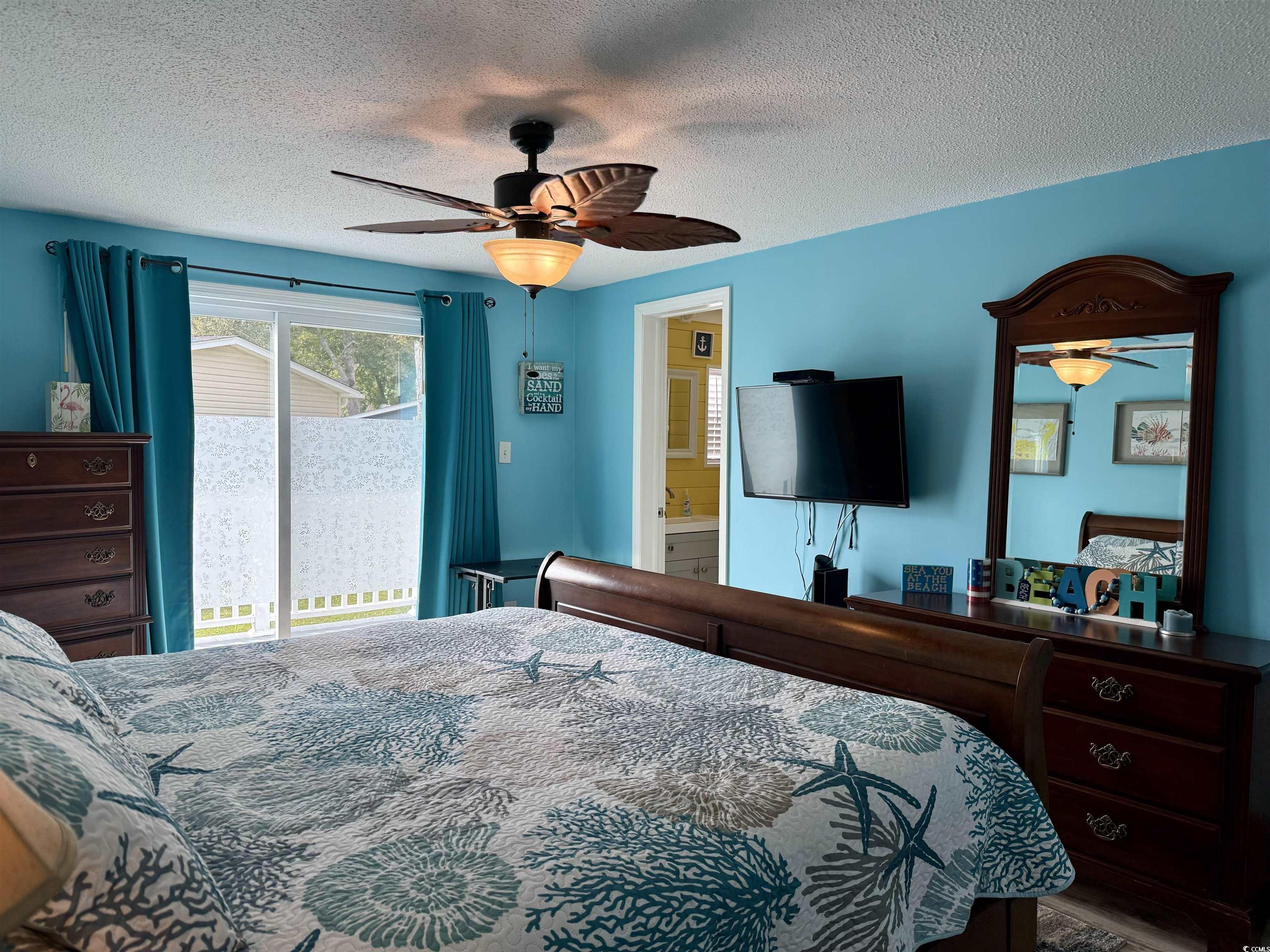 523 Sandpebble Surfside Beach, SC 29575 - Photo 24 of 31 Bedroom featuring ensuite bathroom, a textured cei