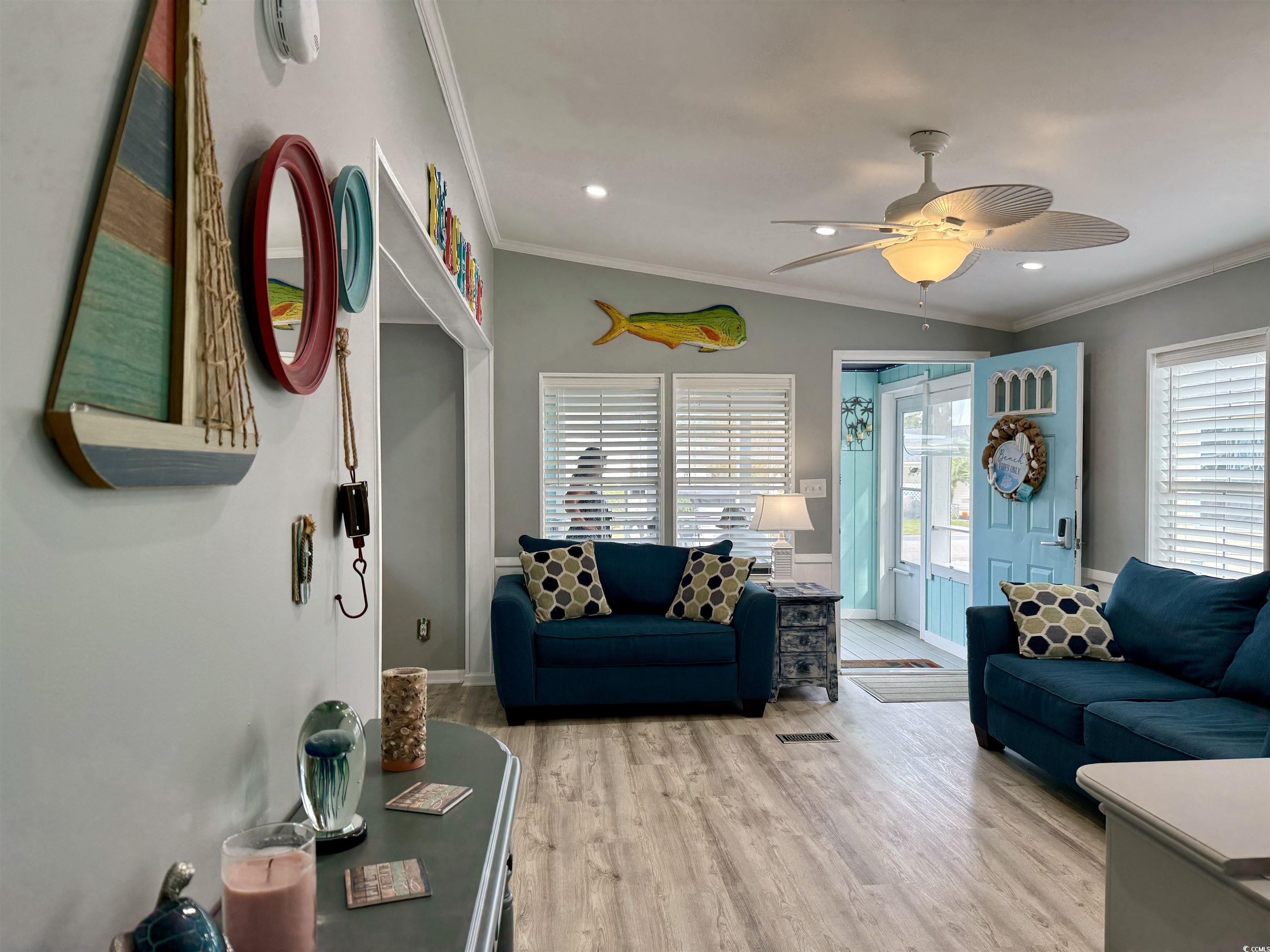 523 Sandpebble Surfside Beach, SC 29575 - Photo 25 of 31 Living room with crown molding, light wood-type fl