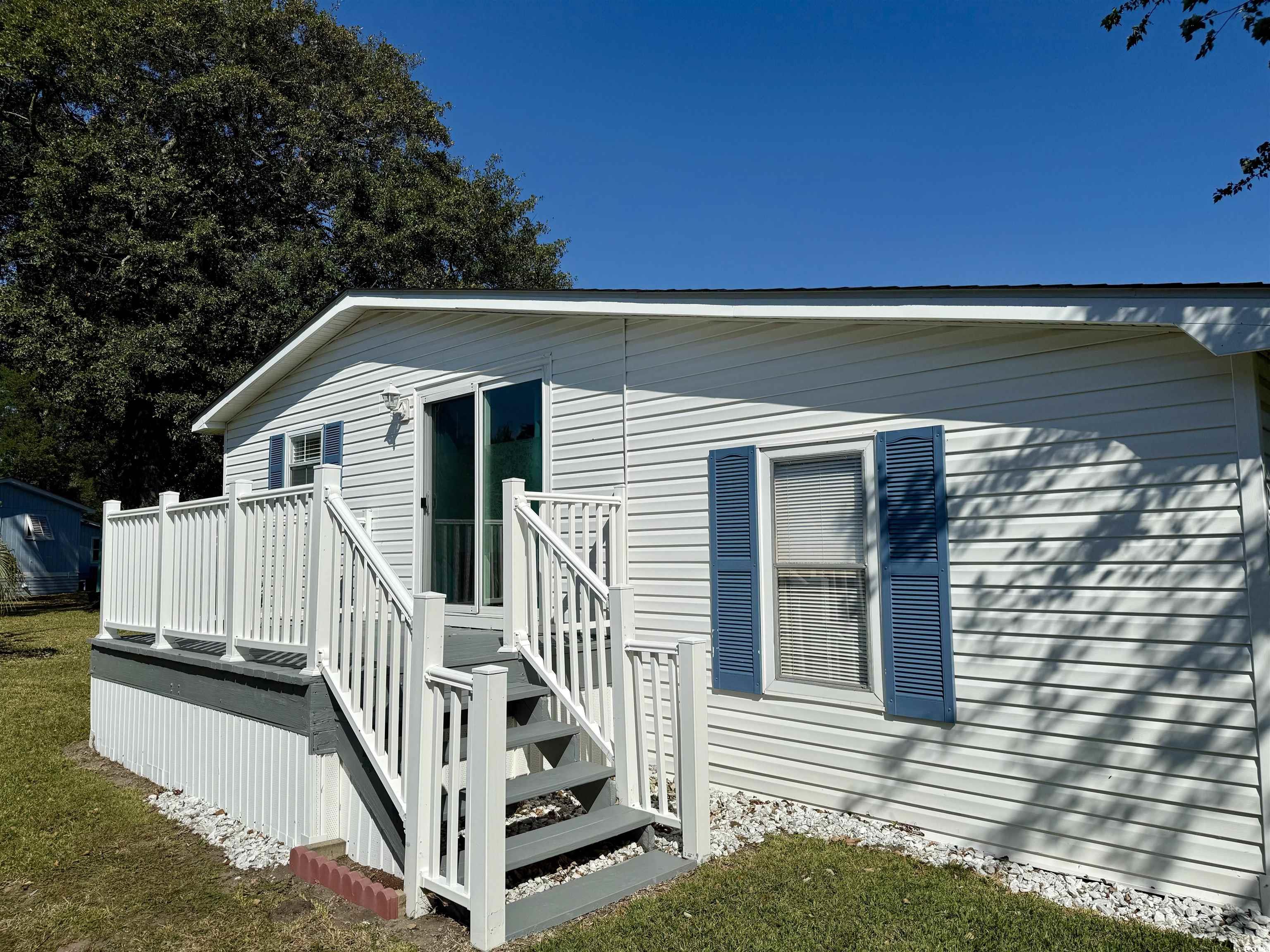 523 Sandpebble Surfside Beach, SC 29575 - Photo 27 of 31 Exterior space featuring a wooden deck and a lawn