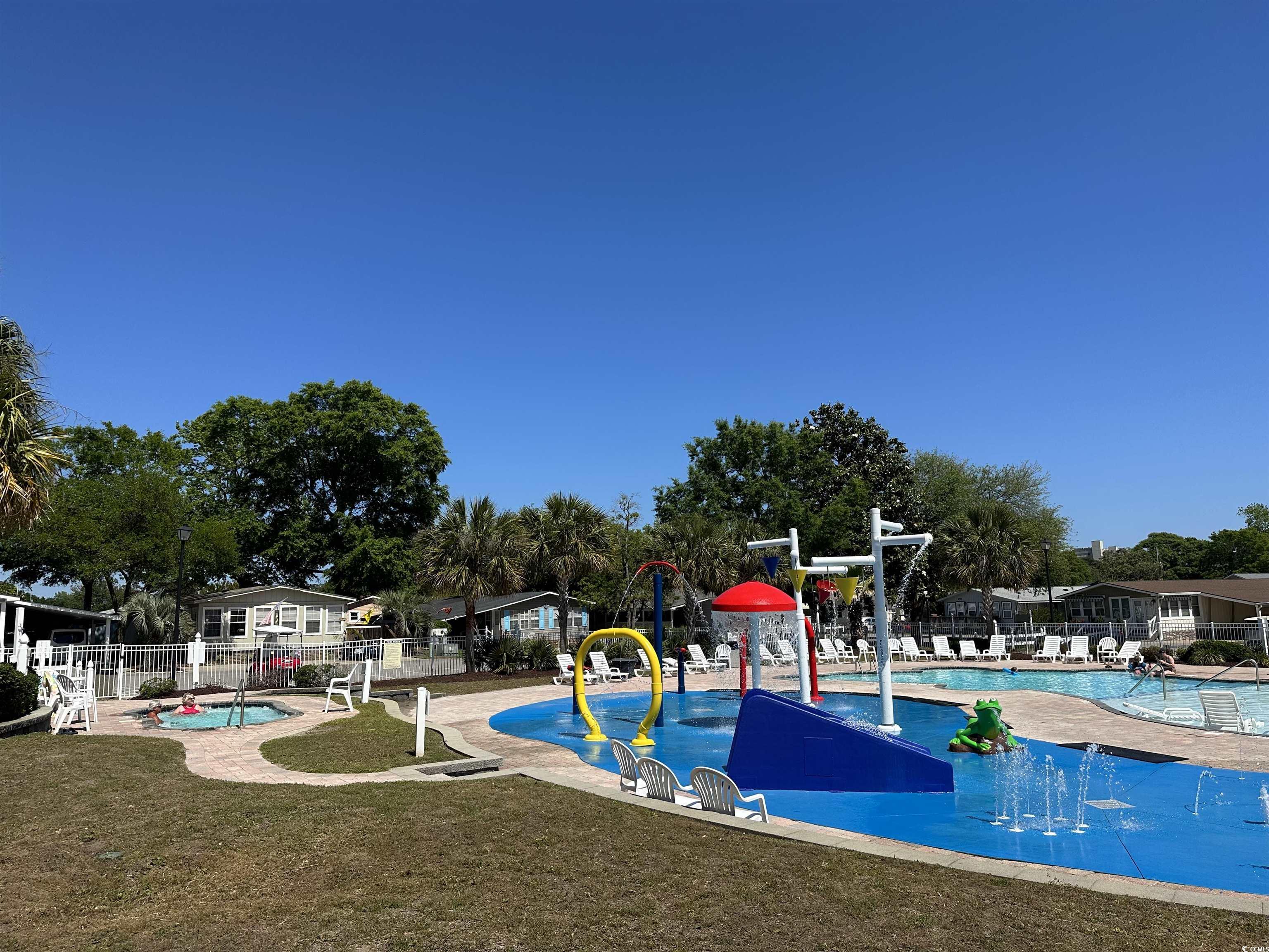 523 Sandpebble Surfside Beach, SC 29575 - Photo 30 of 31 View of jungle gym with a patio, a community pool,