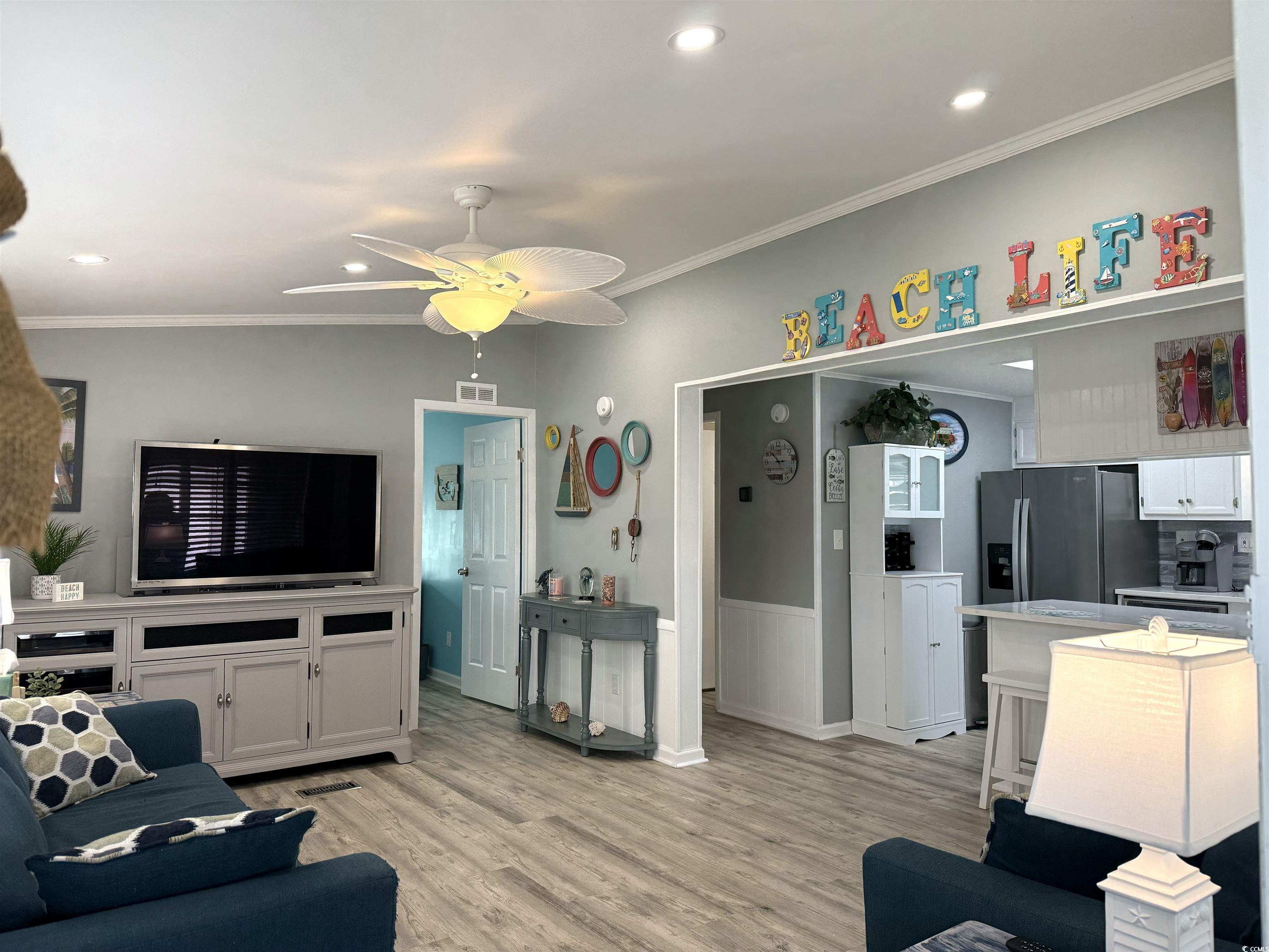 523 Sandpebble Surfside Beach, SC 29575 - Photo 5 of 31 Living room with light wood-type flooring, crown m
