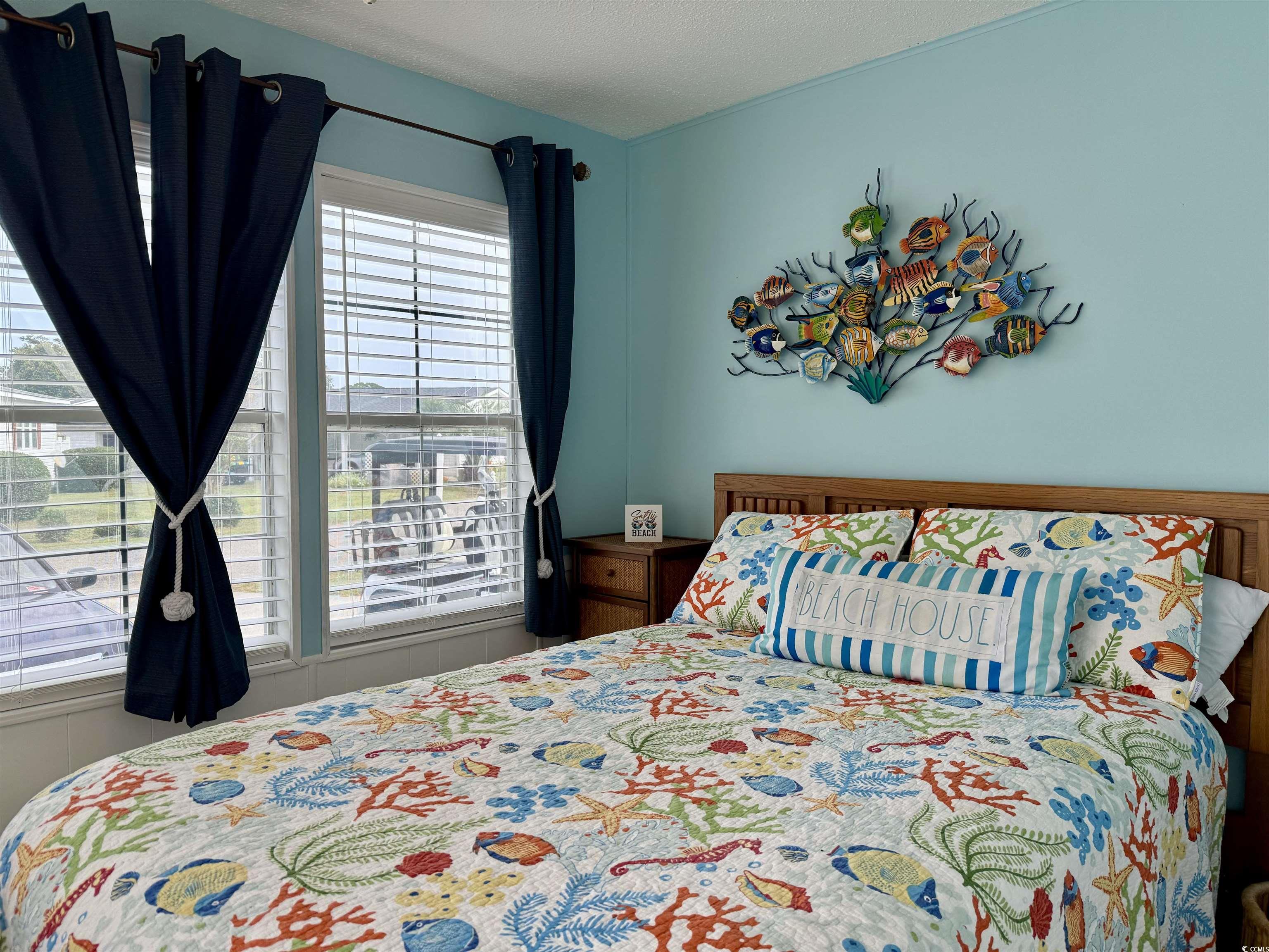 523 Sandpebble Surfside Beach, SC 29575 - Photo 8 of 31 Bedroom with multiple windows and a textured ceili