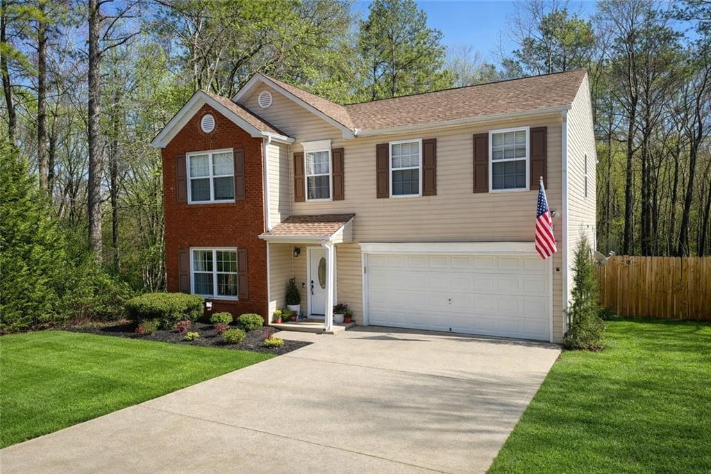 a front view of a house with garden