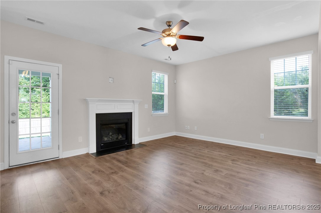 136 Loch Lane Cameron, NC 28326 - Photo 11 of 49 an empty room with windows and fireplace
