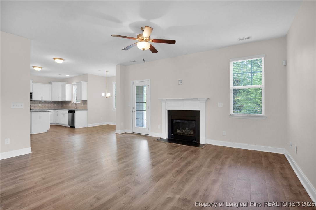 136 Loch Lane Cameron, NC 28326 - Photo 13 of 49 a view of empty room with wooden floor and fireplace