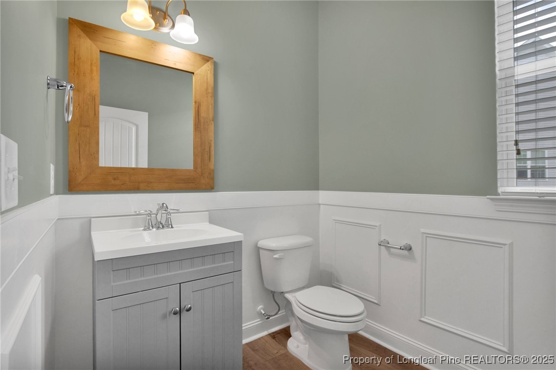 136 Loch Lane Cameron, NC 28326 - Photo 22 of 49 a bathroom with a toilet a sink a vanity and mirror