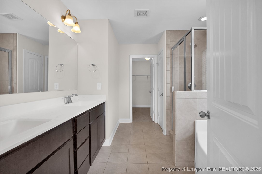 136 Loch Lane Cameron, NC 28326 - Photo 30 of 49 a bathroom with a double vanity sink and a mirror
