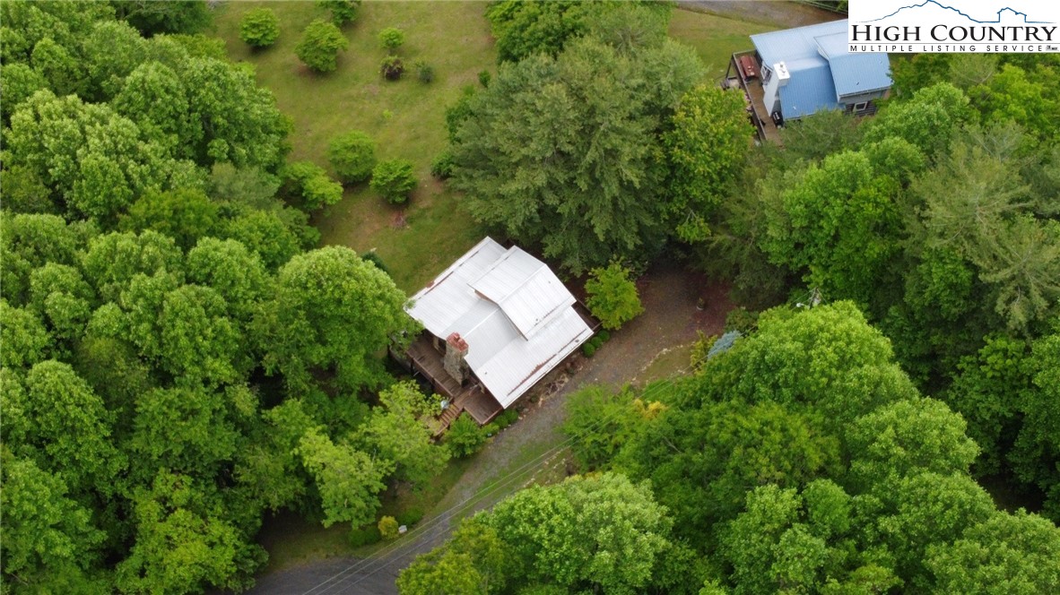 710 River Hills Road Lansing, NC 28643 - Photo 31 of 38 an aerial view of a house with a yard and lake view
