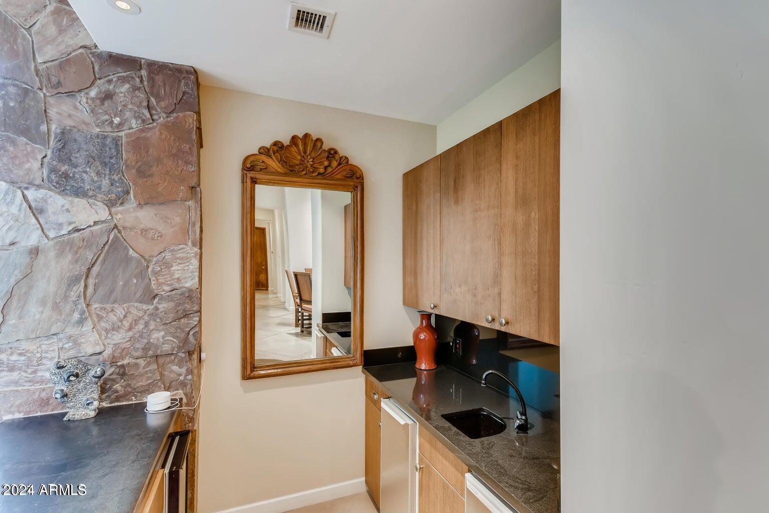 7475 East Gainey Ranch Road, Unit 26 Scottsdale, AZ 85258 - Photo 23 of 25 Wet Bar Downstairs Off Family Room