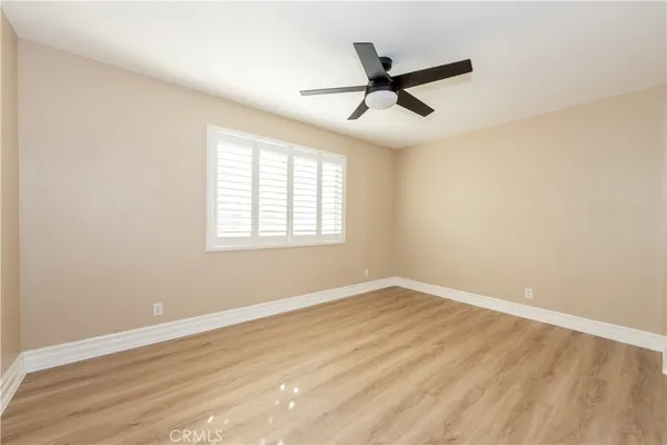 a view of a room with wooden floor and windows