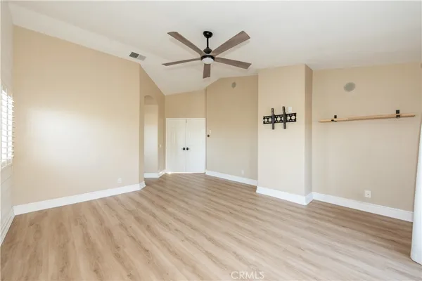 wooden floor in an empty room with a window