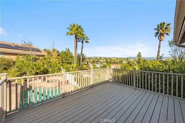 a view of a balcony with wooden floor