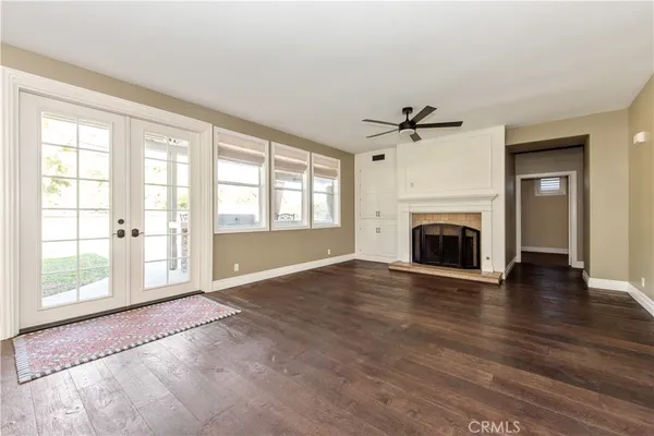 wooden floor in an empty room with a fireplace