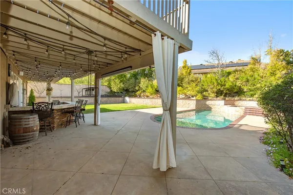 a view of a porch with chairs and backyard