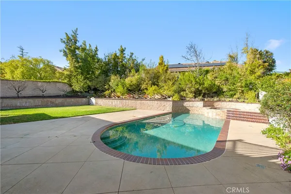 a view of a swimming pool with a yard