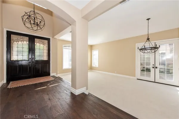 a view of a room with wooden floor and windows