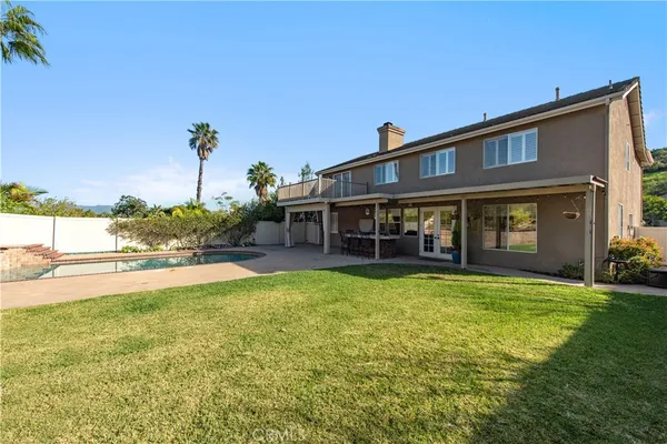 a view of house with yard and seating area