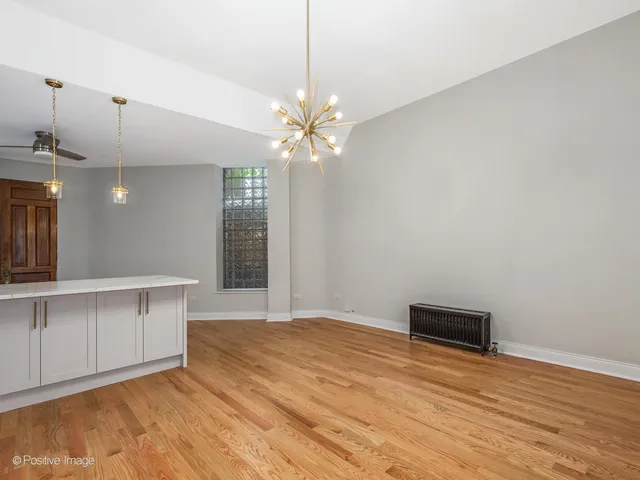 a view of an empty room with window and cabinet