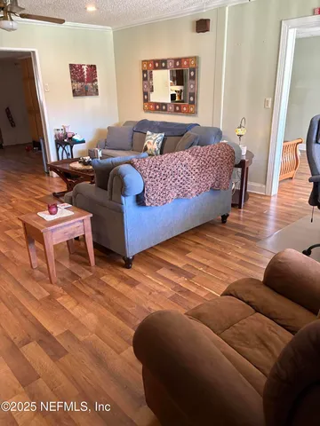 a bedroom with furniture and a wooden floor