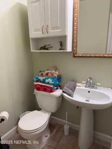 a bathroom with a sink toilet and a mirror