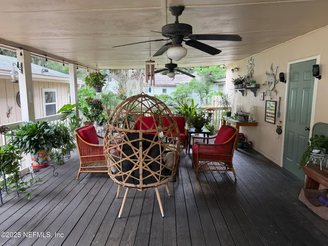 a view of a dinning table and chairs in patio of the house