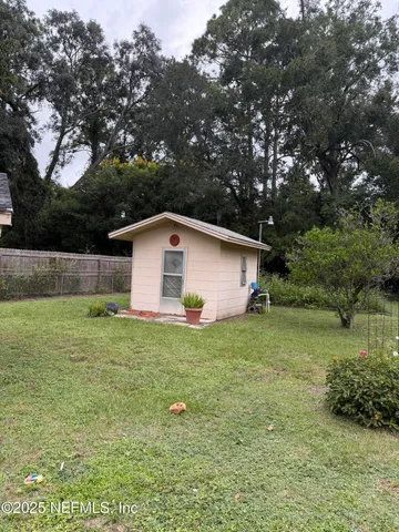 a house that has a tree in front of it