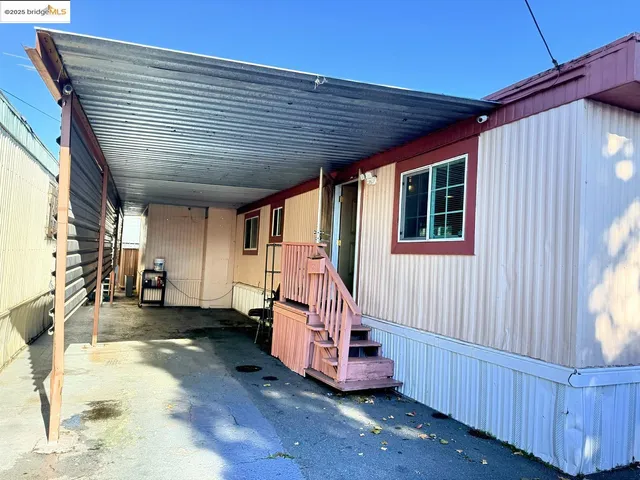 a view of a house with wooden roof and stairs