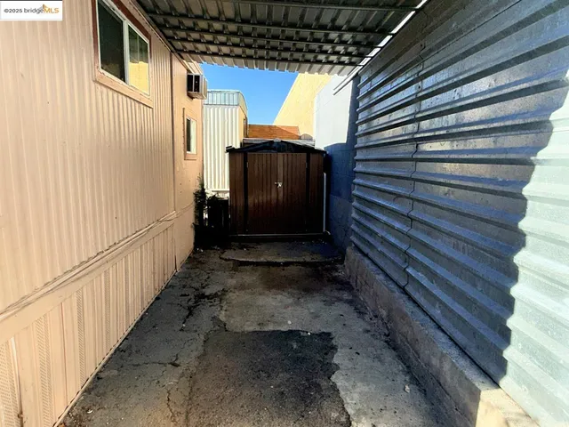 a view of a house with wooden walls and stairs