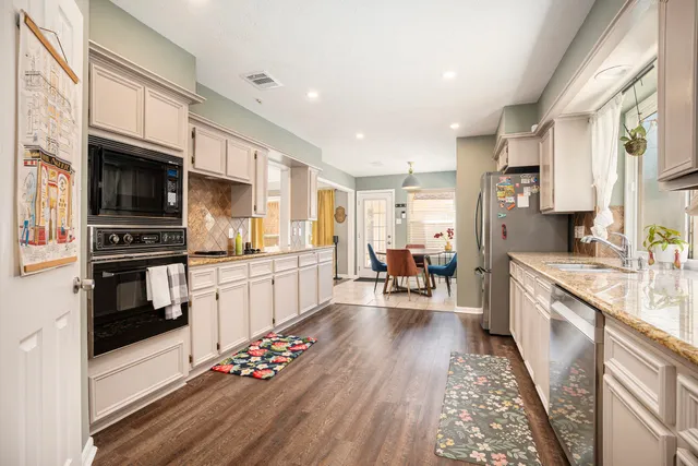 a bedroom with a large bed a flat tv screen and a large window
