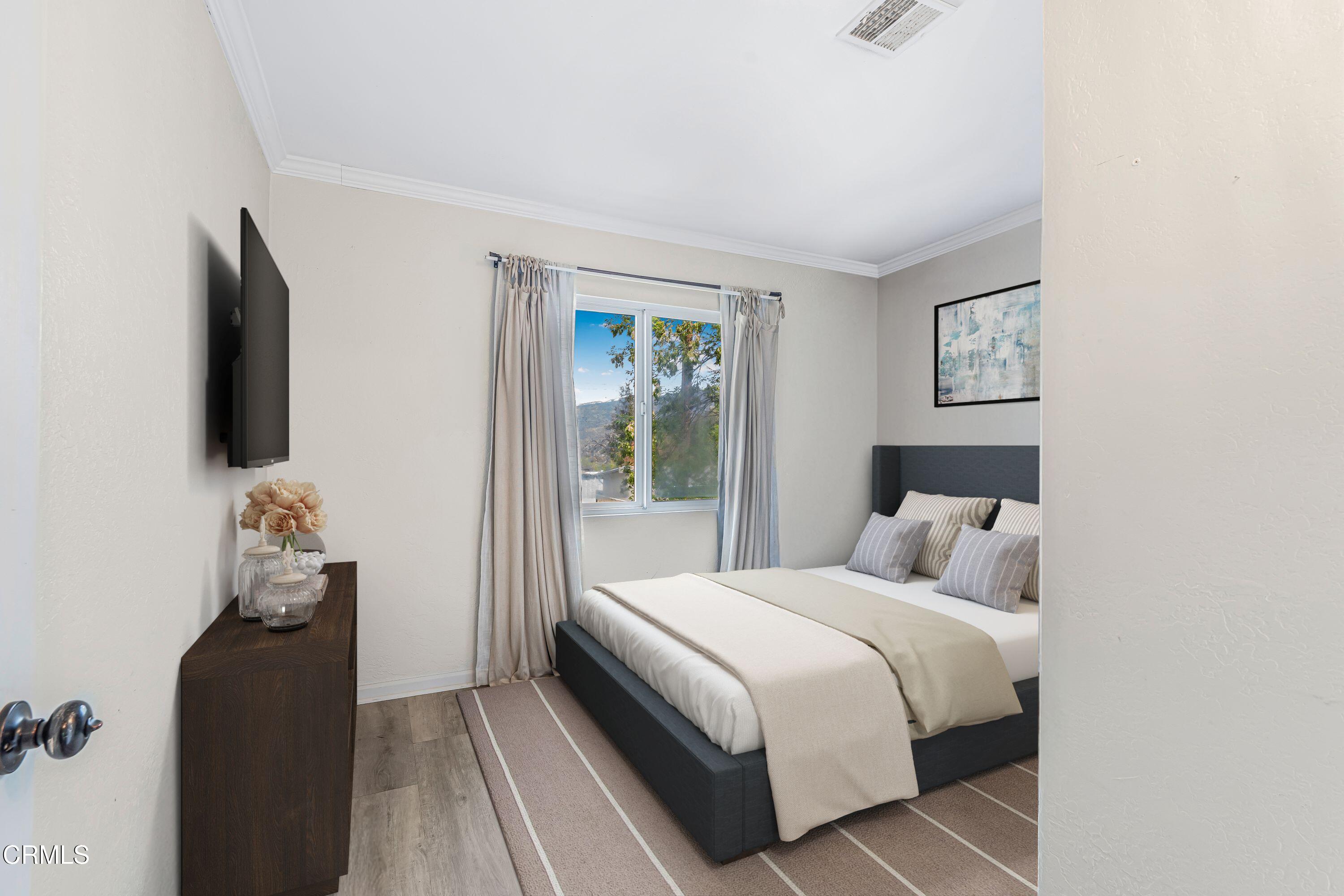 6045 Oak Knolls Road Simi Valley, CA 93063 - Photo 15 of 25 a bedroom with bed and a flat tv screen