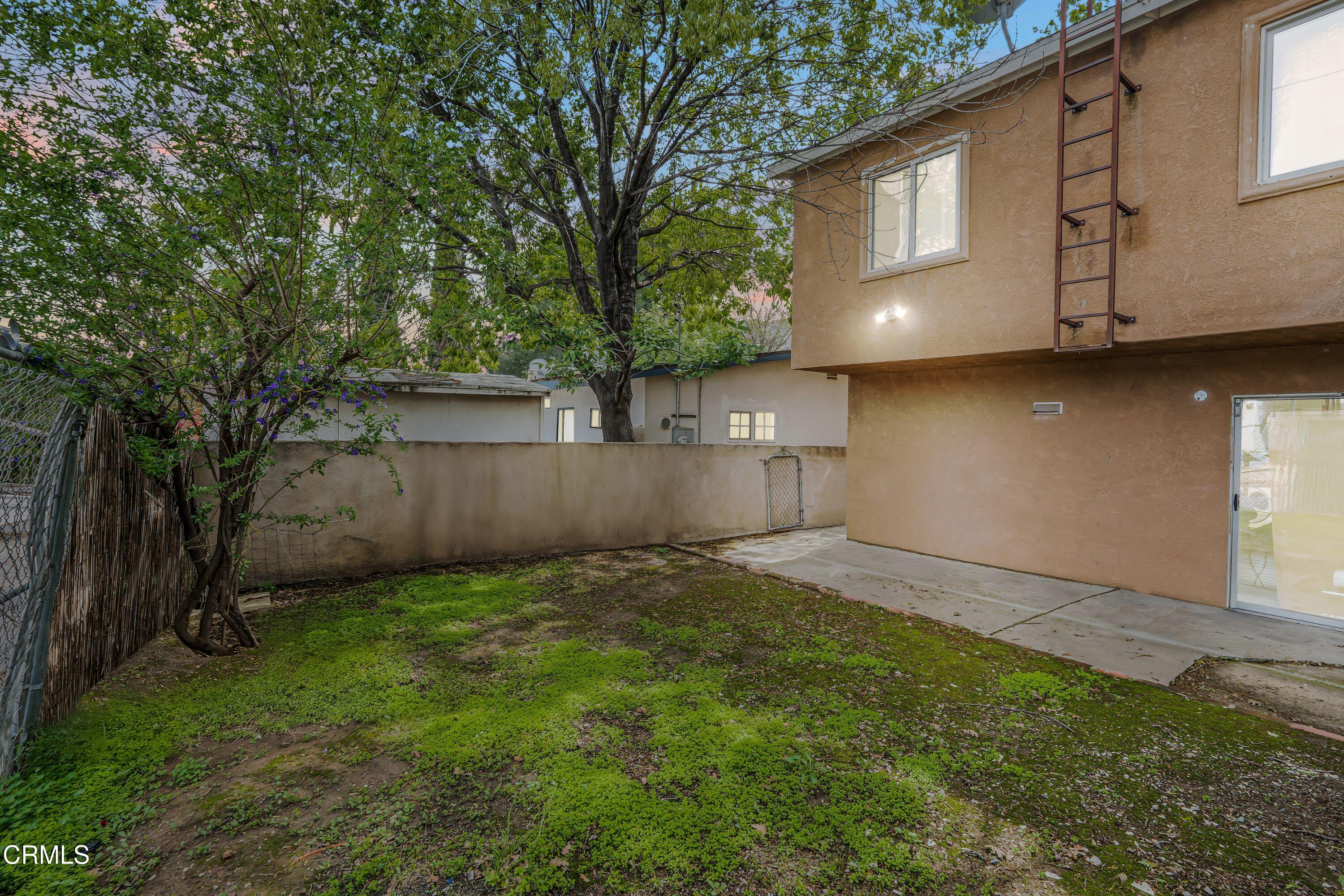 6045 Oak Knolls Road Simi Valley, CA 93063 - Photo 18 of 25 a view of a backyard with plants and large tree
