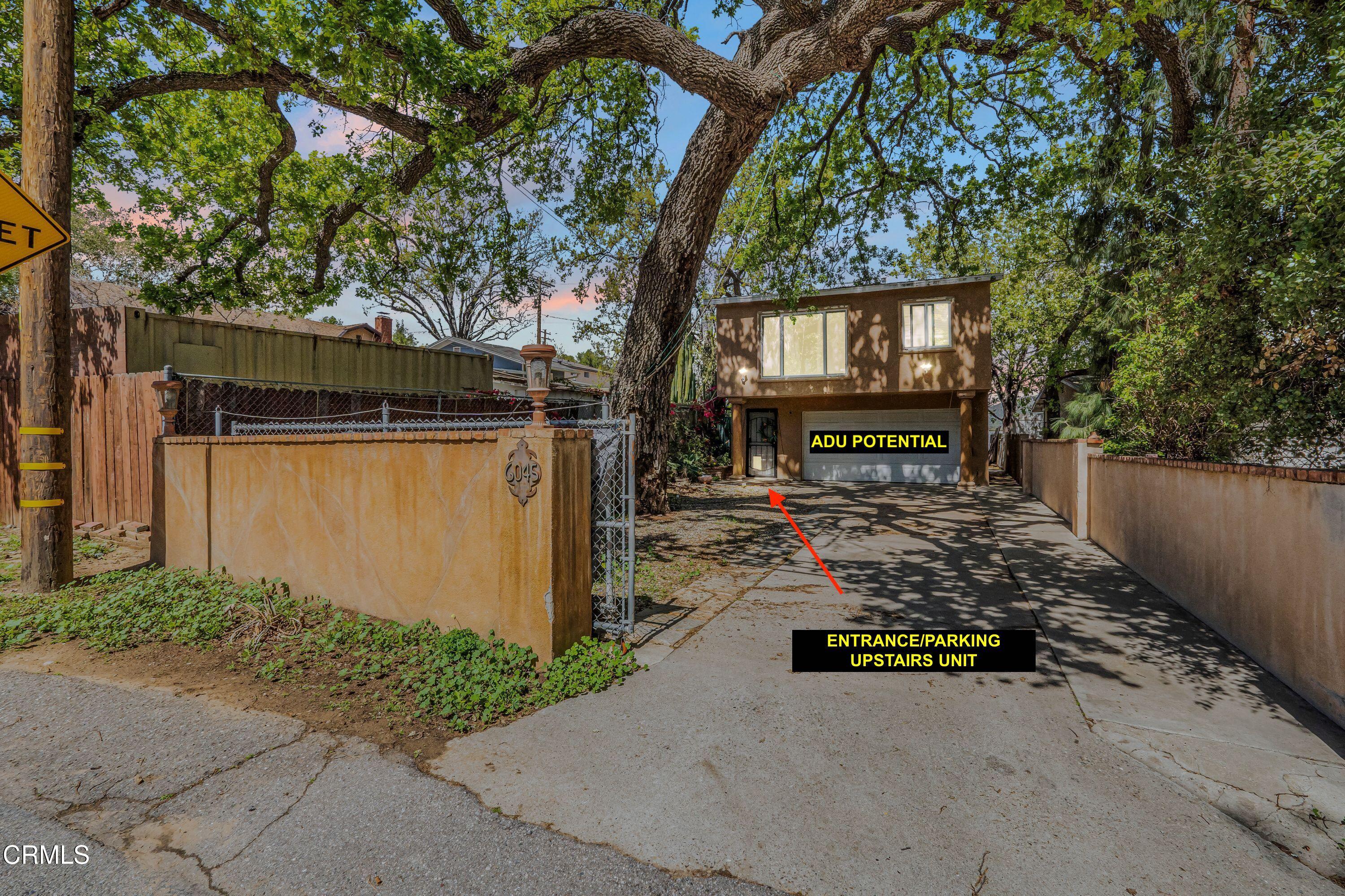 6045 Oak Knolls Road Simi Valley, CA 93063 - Photo 2 of 25 a view of a yard with wooden fence and a bench