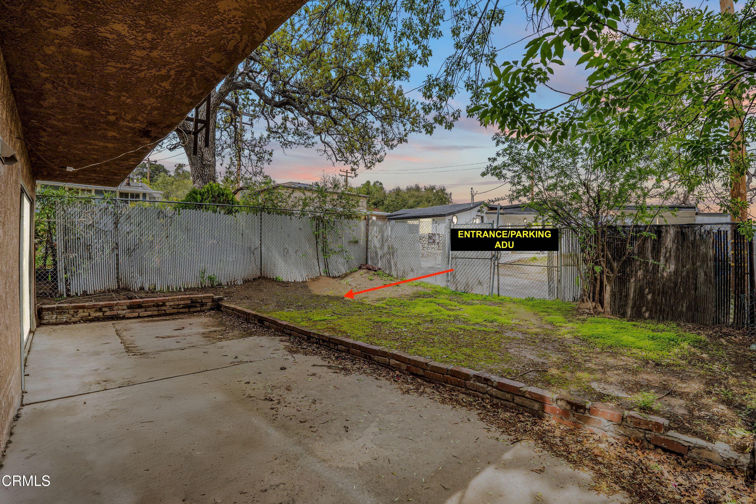 6045 Oak Knolls Road Simi Valley, CA 93063 - Photo 3 of 25 a backyard of a house with a table and chairs