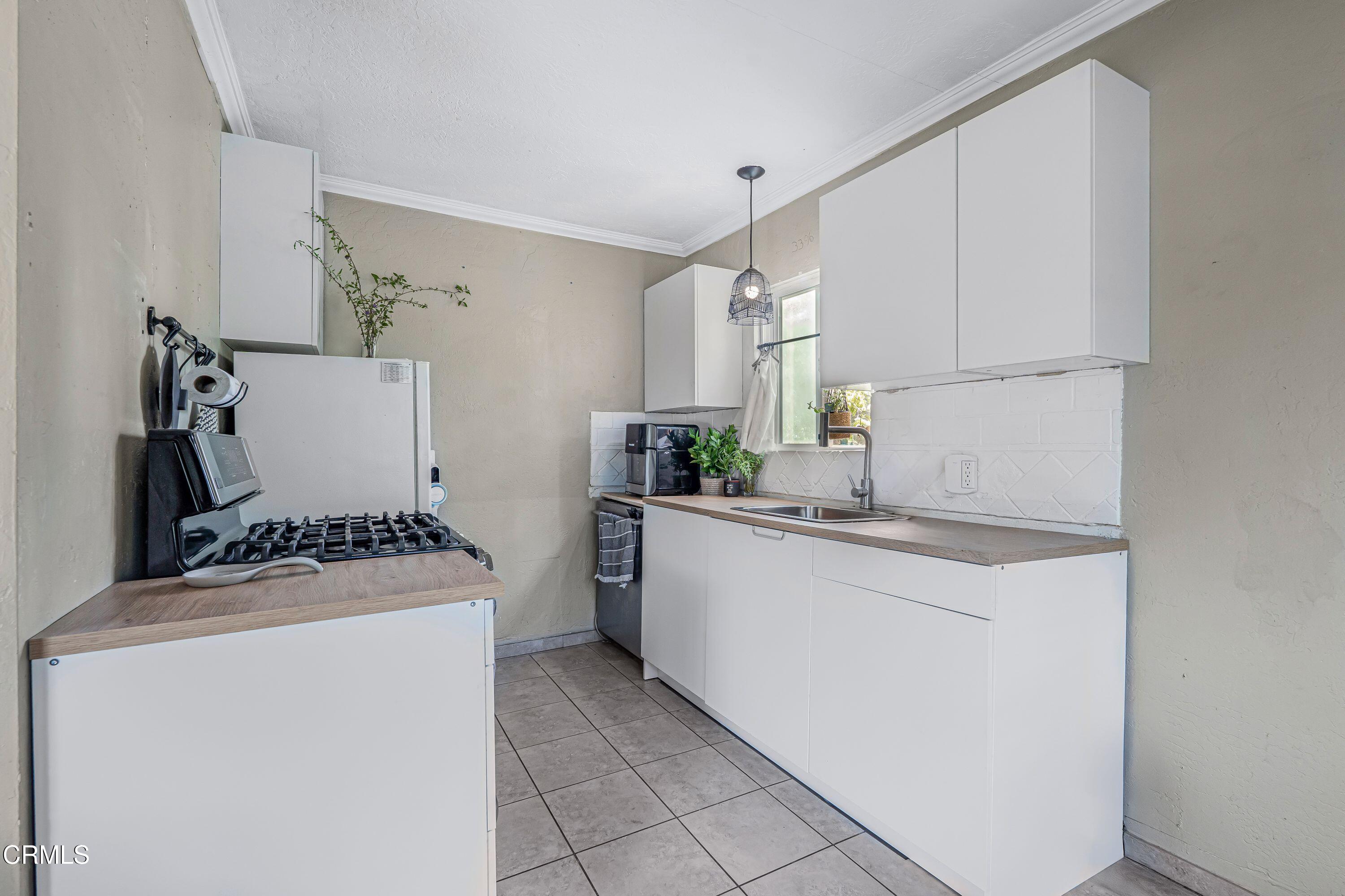 6045 Oak Knolls Road Simi Valley, CA 93063 - Photo 9 of 25 a kitchen with a stove and a refrigerator