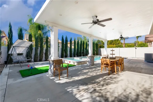 a view of a patio with a table and chairs
