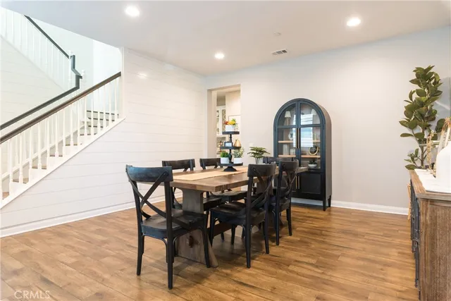 a view of a hallway to rooms and wooden floor