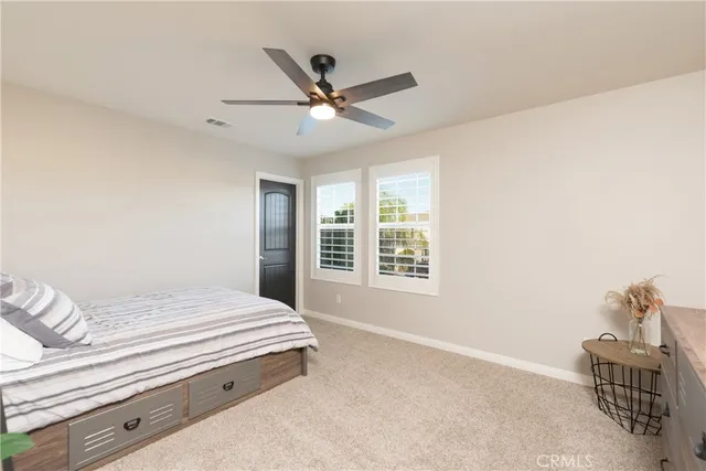 a front view of a house with a yard table and chairs