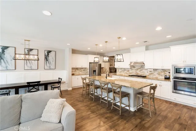 a living room with lots of furniture and kitchen view