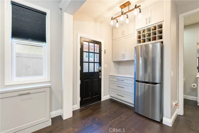 a kitchen with a refrigerator and window