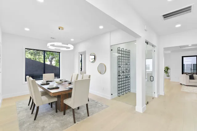 a large kitchen with kitchen island a sink table and chairs